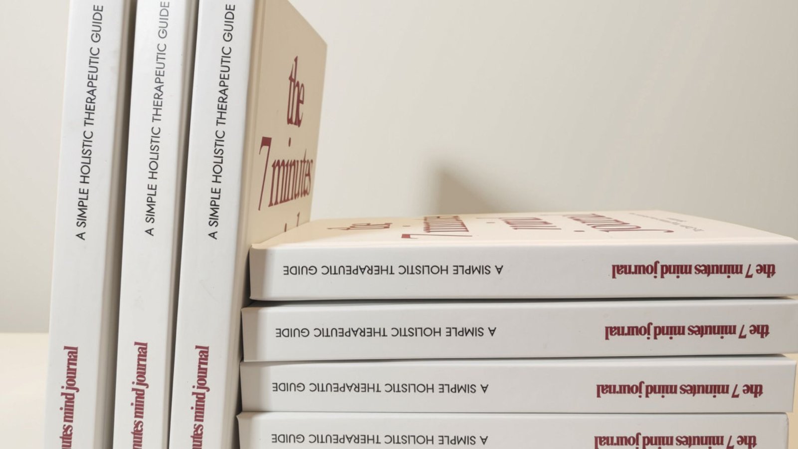A row of 7-Minute Mind Journal hardcovers showing the spine and title